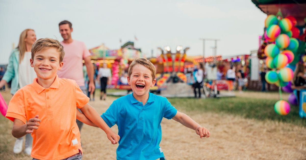 Stock image of a family with children at a summer carnival