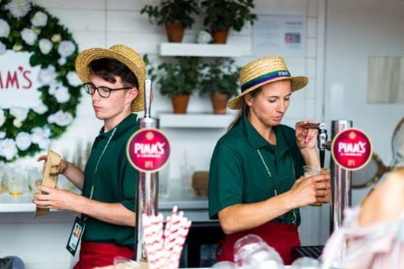 Two people serving Pimm's at Wimbledon