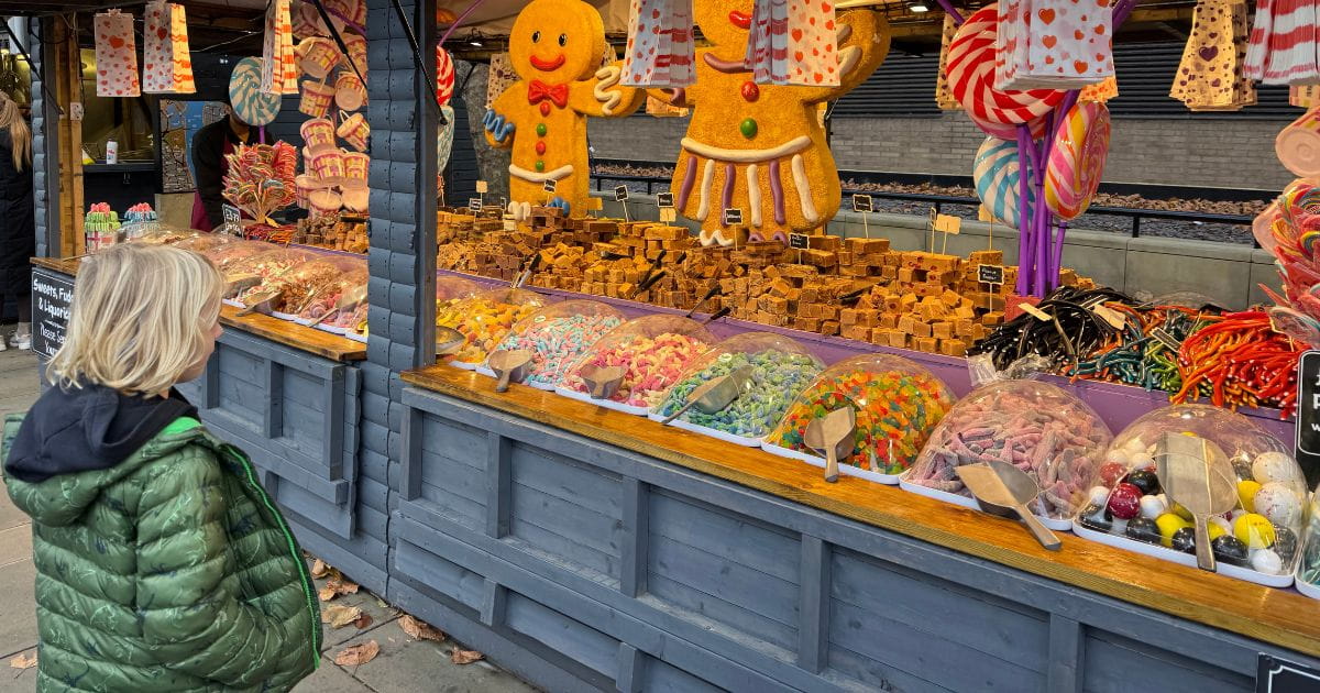 A child gazing at a sweet stall