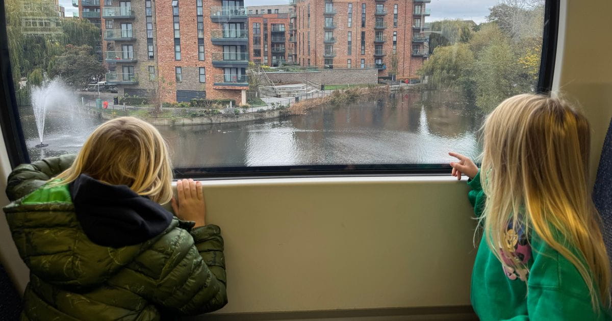 Children looking out the window of a train