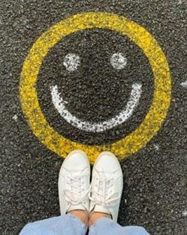 A smiley face painted on a road
