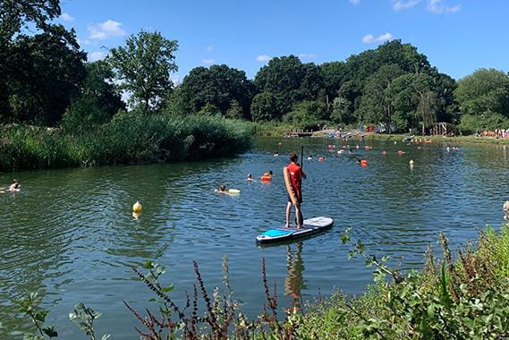 A group of people swimming in a lake