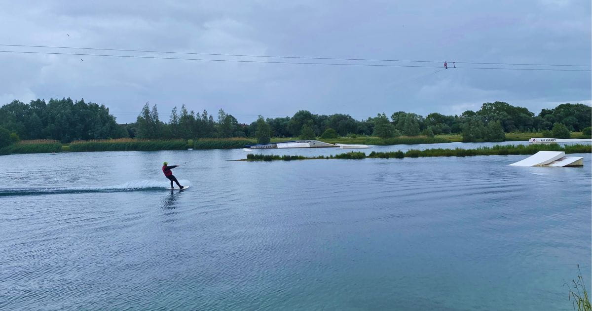 A person on a lake doing wakeboarding