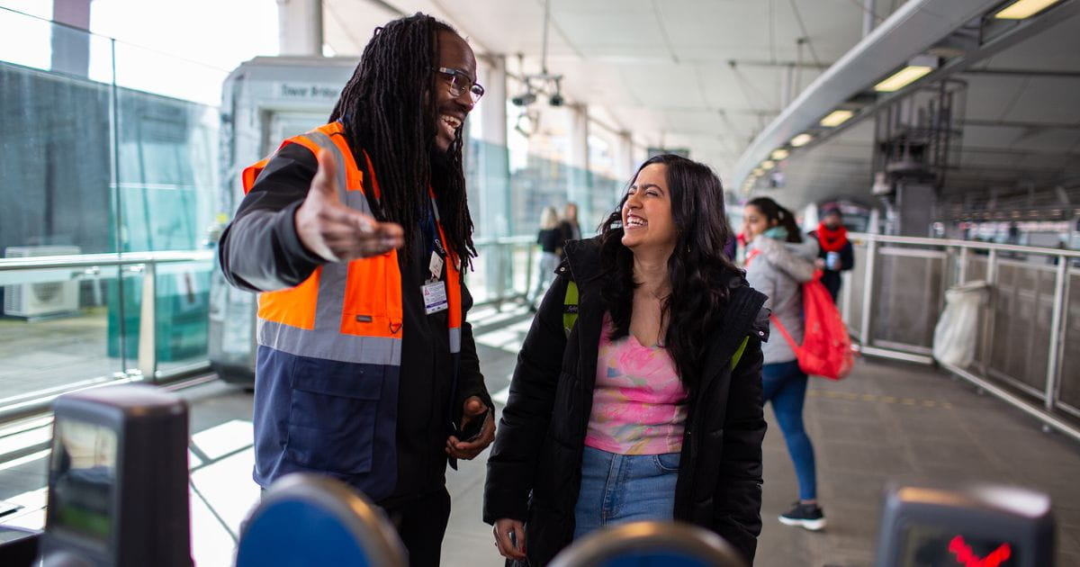 Thameslink train passenger with gateline staff