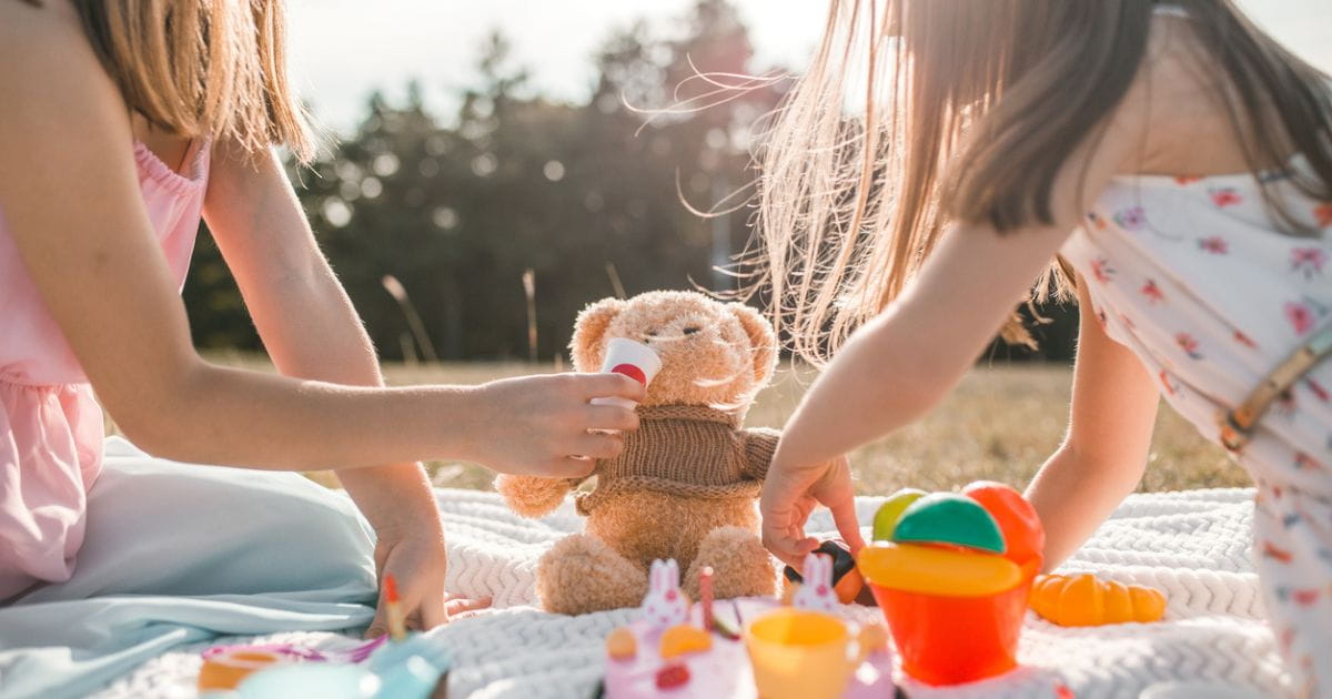 Children playing teddy bears picnic