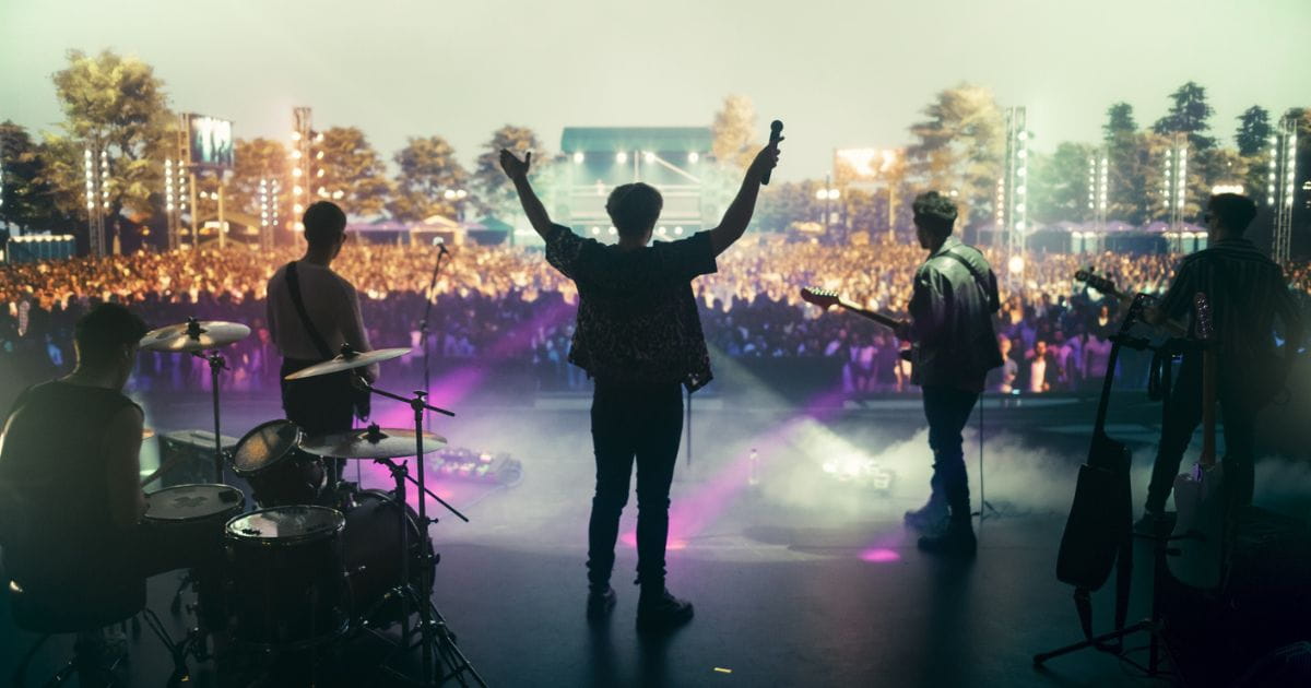 stock image of a band on stage at a summer festival