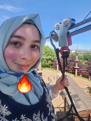 Closeup of a girl at the Go-Ape adventure park on the Tarzan swing