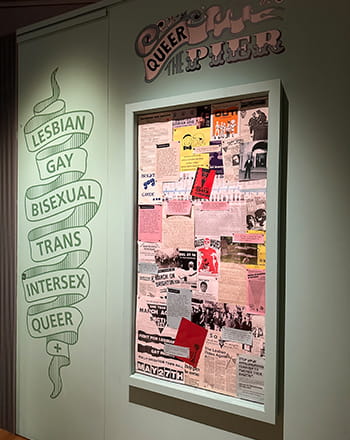 Poster board and wall signs at Queer the Pier