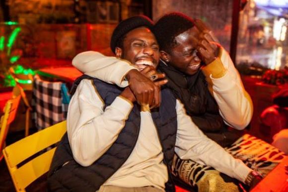 Two friends laugh and smile