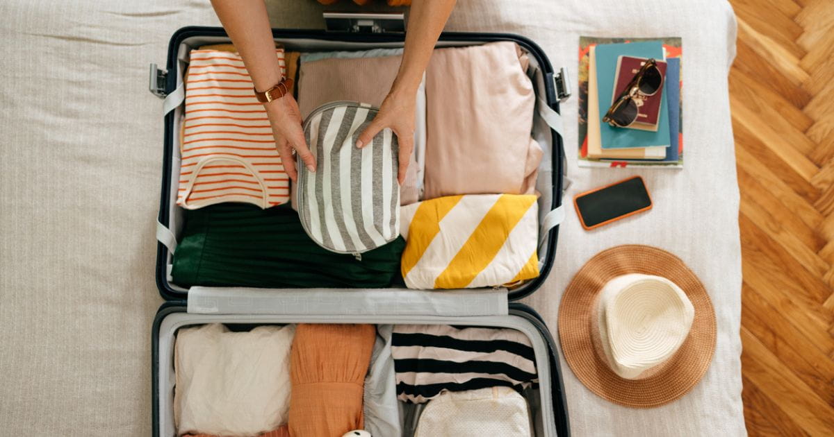 Stock image of a person packing a suitcase